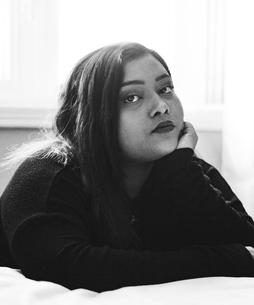 Person in a meditative pose looking serene and calm.