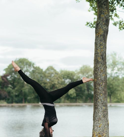 Woman performing a deep hip-opening yoga stretch.